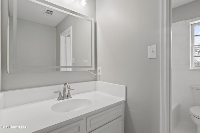 bathroom featuring a bathtub, visible vents, toilet, and vanity