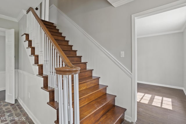 stairway featuring baseboards and ornamental molding