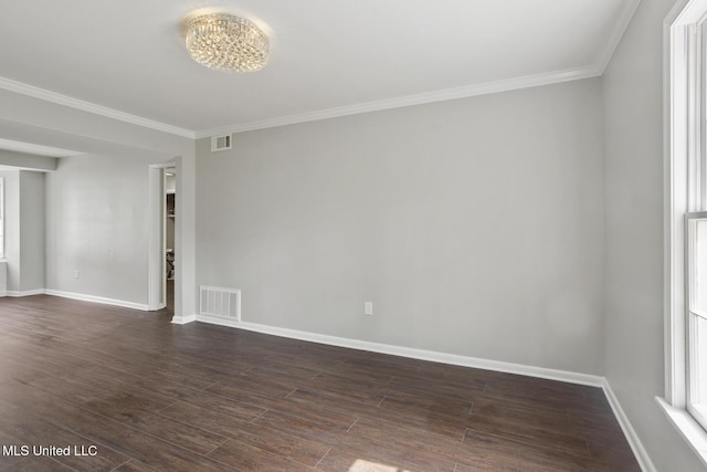 spare room with visible vents, baseboards, and dark wood finished floors