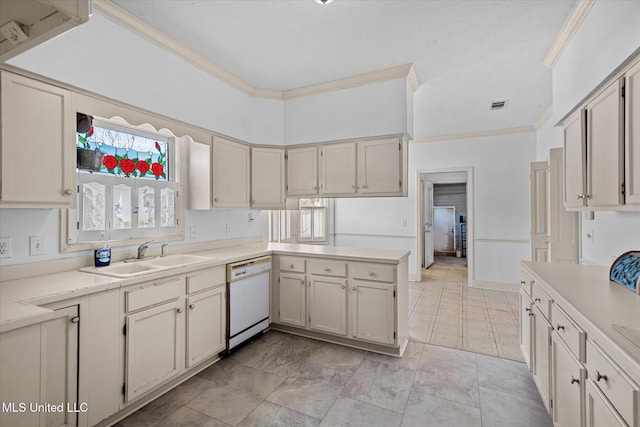 kitchen featuring visible vents, crown molding, light countertops, white dishwasher, and a sink