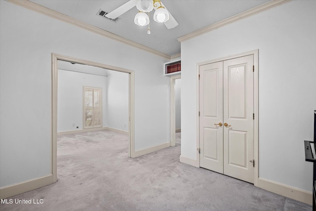 unfurnished bedroom with carpet flooring, baseboards, visible vents, and ornamental molding