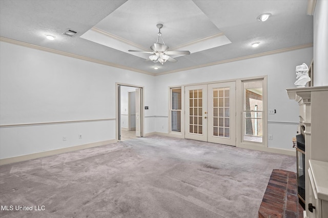 unfurnished living room featuring carpet flooring, french doors, a raised ceiling, and visible vents