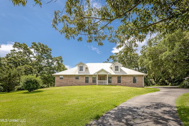 cape cod house with a front lawn