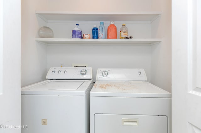 clothes washing area featuring washer and dryer