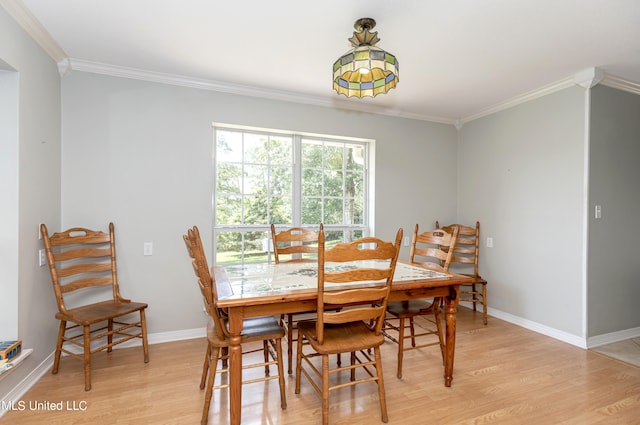 dining area with crown molding and light wood-type flooring