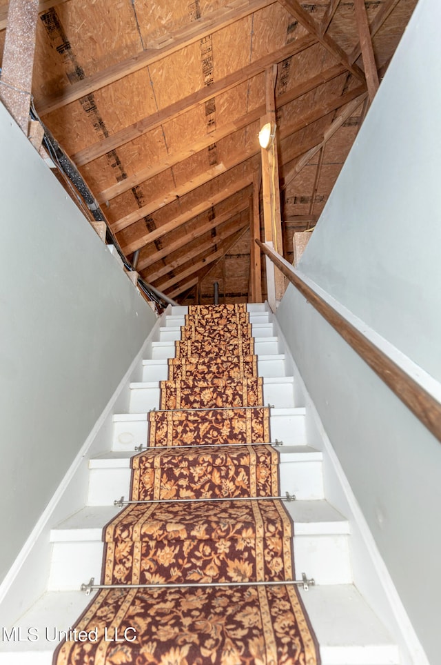 stairway with vaulted ceiling