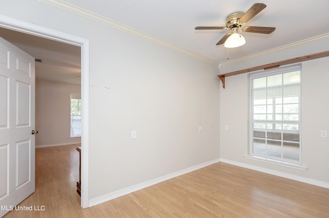 empty room featuring a wealth of natural light, light wood-type flooring, and ceiling fan