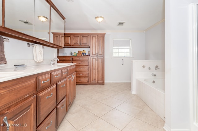 bathroom featuring vanity, tile patterned floors, ornamental molding, and tiled tub