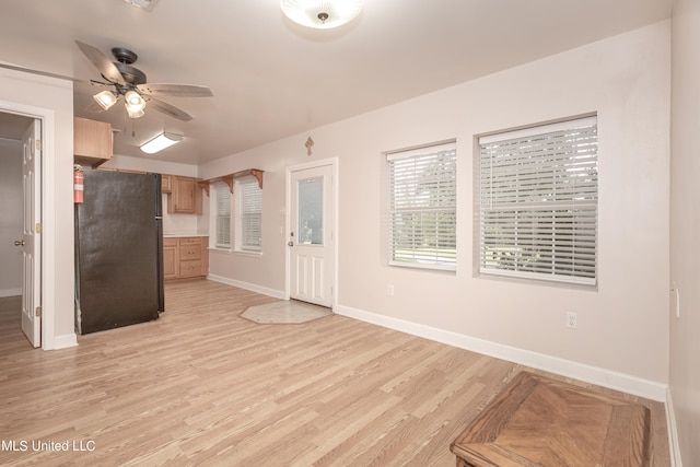 interior space featuring light wood-type flooring and ceiling fan