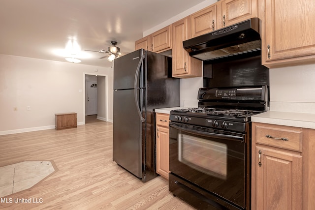 kitchen with light brown cabinetry, black appliances, light hardwood / wood-style floors, and ceiling fan