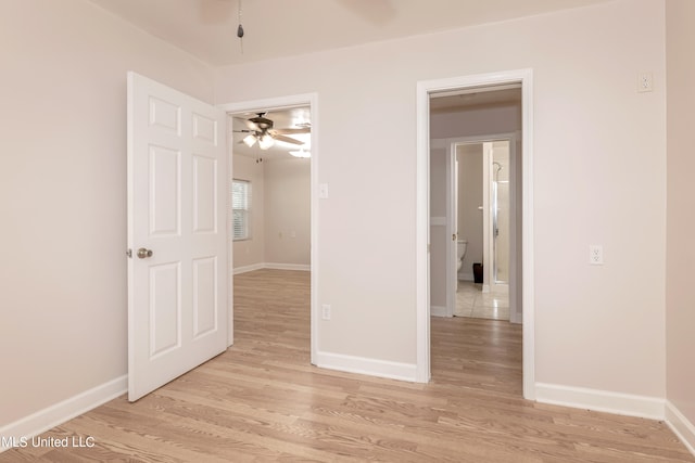 empty room with ceiling fan and light wood-type flooring