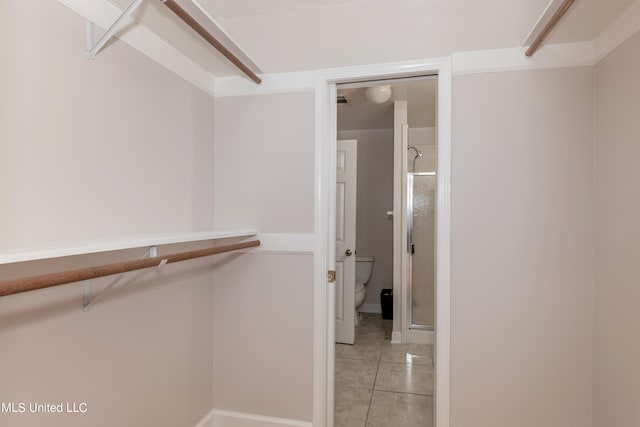 spacious closet featuring light tile patterned floors