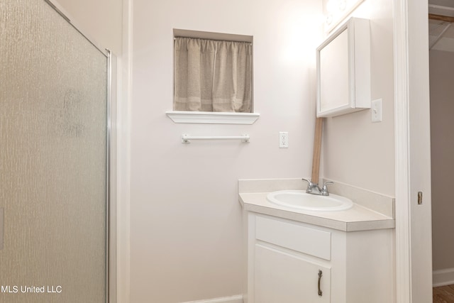 bathroom with vanity and a shower with shower door