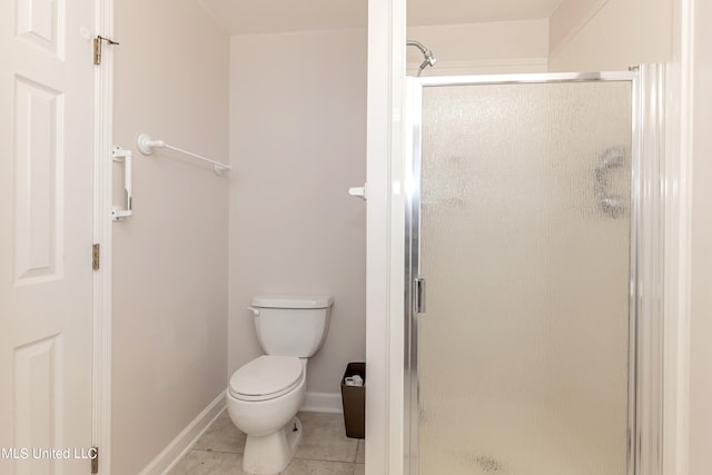 bathroom with toilet, walk in shower, and tile patterned floors