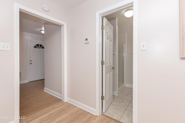 corridor with light wood-type flooring