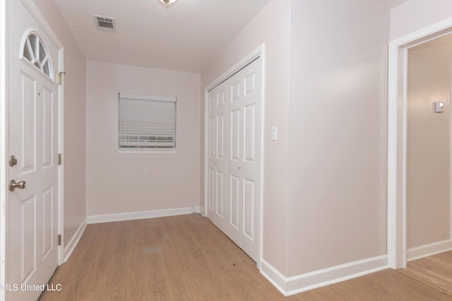 hall with light hardwood / wood-style flooring