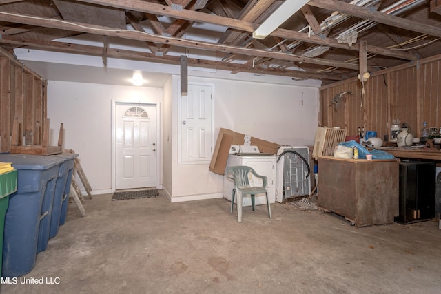 basement featuring washer / dryer and wooden walls