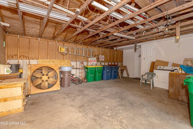 garage featuring wood walls and washer / clothes dryer