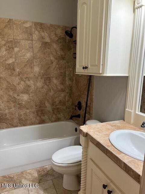 full bathroom with vanity, tiled shower / bath combo, toilet, and tile patterned floors