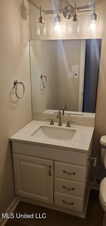 bathroom with toilet and vanity