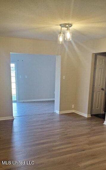 interior space with dark wood finished floors and baseboards