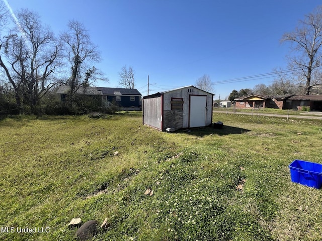 view of yard with an outdoor structure and a shed