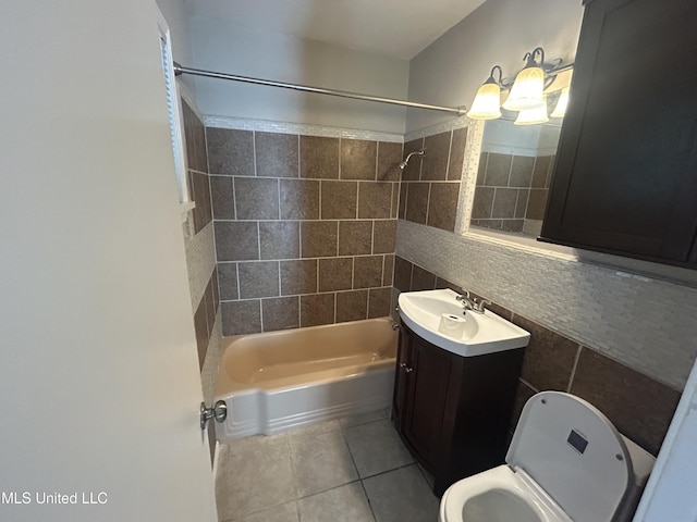 600 Jackson Ave, Mccomb, MS 39648 - bathroom featuring tile patterned flooring,  shower combination, vanity, tile walls, and decorative backsplash
