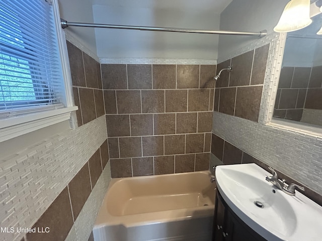 600 Jackson Ave, Mccomb, MS 39648 - bathroom featuring tile walls,  shower combination, vanity, and decorative backsplash