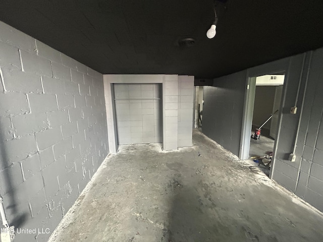 600 Jackson Ave, Mccomb, MS 39648 - unfurnished bedroom featuring concrete block wall and concrete floors