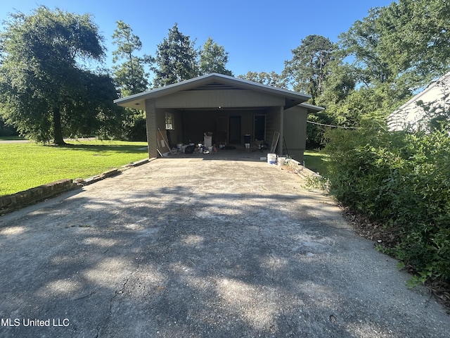 600 Jackson Ave, Mccomb, MS 39648 - garage featuring concrete driveway and an attached carport