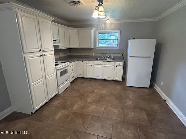 600 Jackson Ave, Mccomb, MS 39648 - kitchen with white appliances, under cabinet range hood, white cabinets, dark countertops, and crown molding