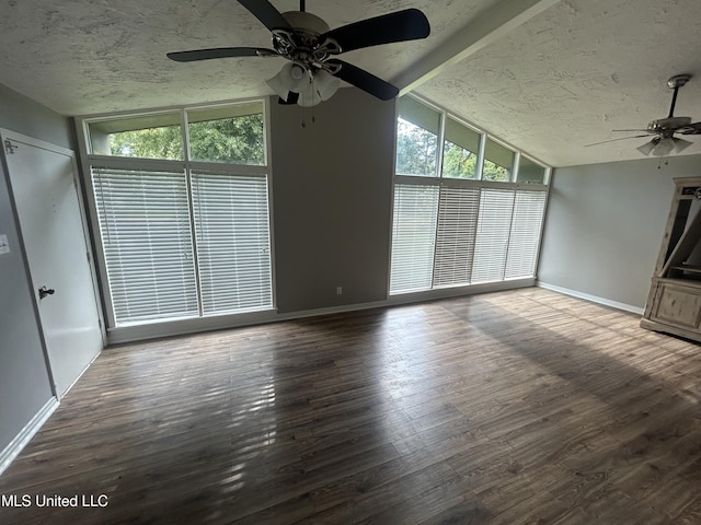 600 Jackson Ave, Mccomb, MS 39648 - unfurnished living room with a ceiling fan, lofted ceiling, plenty of natural light, wood finished floors, and a textured ceiling
