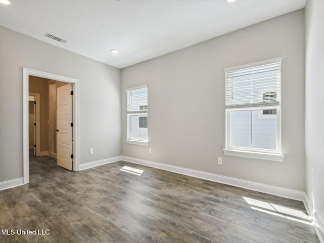 unfurnished bedroom featuring wood finished floors, visible vents, recessed lighting, and baseboards