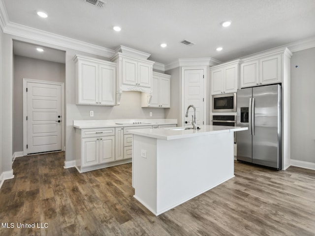 kitchen with stainless steel appliances, light countertops, a sink, white cabinetry, and visible vents