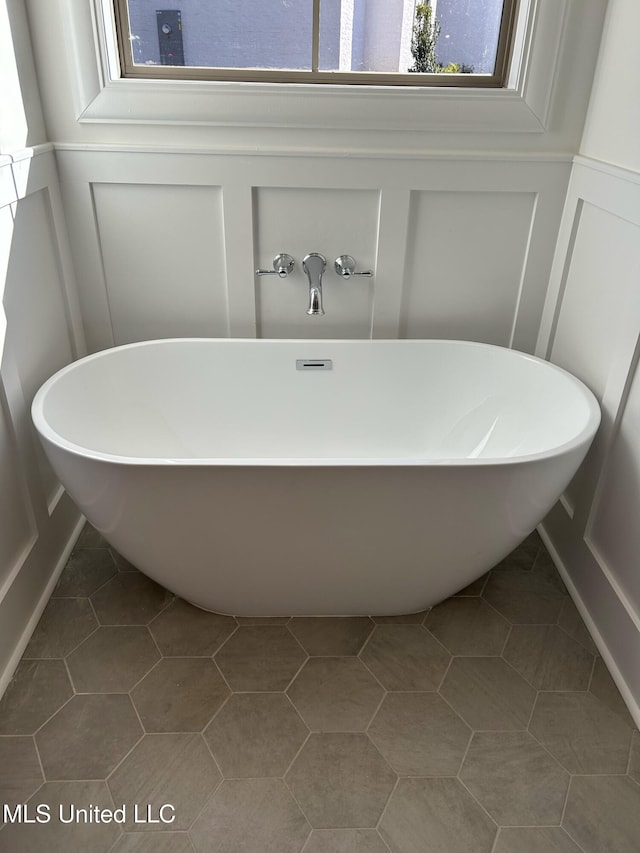 bathroom featuring tile patterned flooring and a bathtub