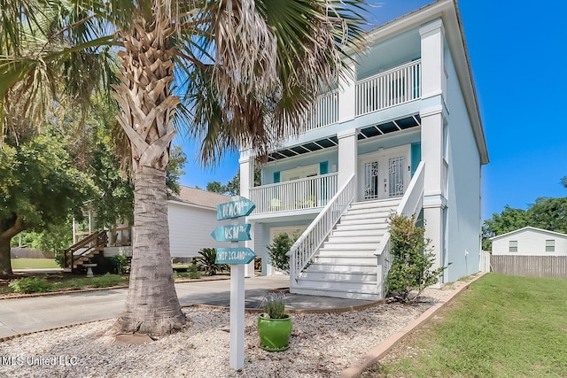 view of front of property with stairs and covered porch