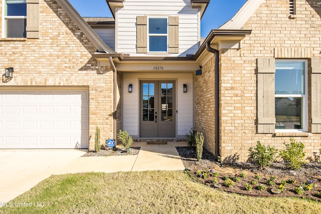 entrance to property with french doors and a garage