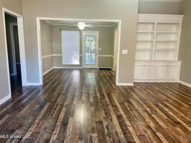 interior space featuring built in features, baseboards, dark wood finished floors, ceiling fan, and crown molding