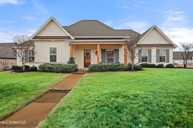 view of front of home with a porch and a front yard