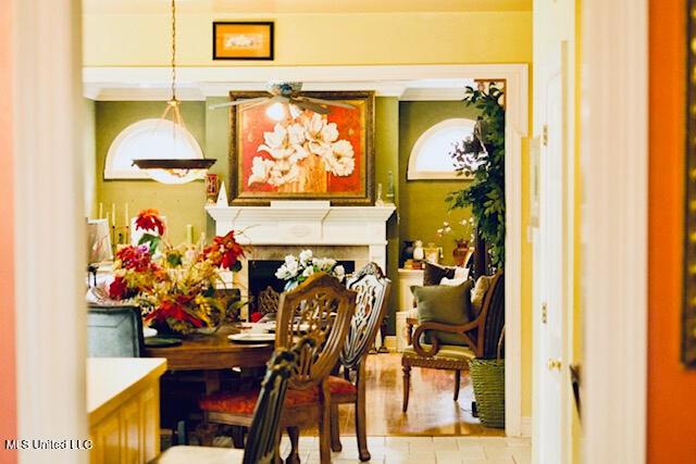 interior space featuring a ceiling fan and a fireplace