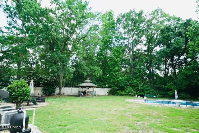 view of yard with a gazebo, a fenced in pool, and a fenced backyard