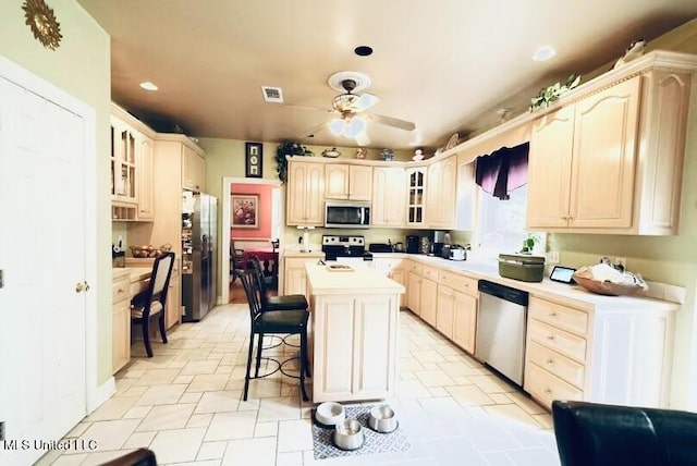 kitchen with glass insert cabinets, appliances with stainless steel finishes, ceiling fan, and visible vents