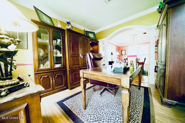 office space featuring crown molding and light wood-type flooring