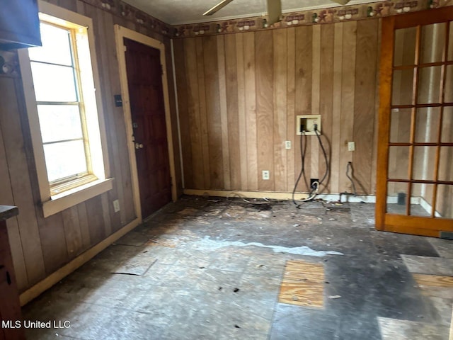 empty room with a wealth of natural light and wooden walls