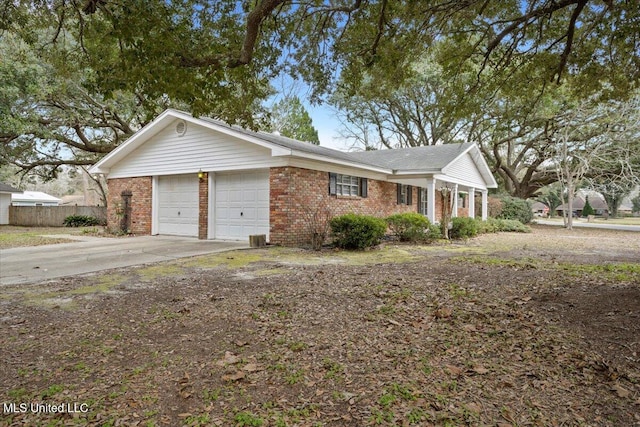 single story home featuring a garage, driveway, fence, and brick siding