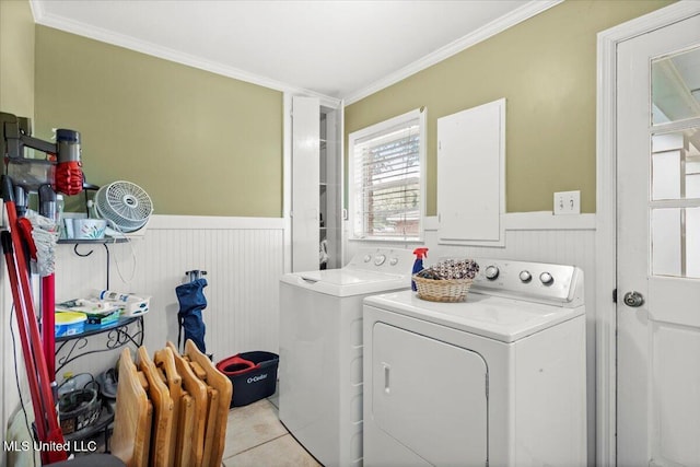 clothes washing area featuring laundry area, wainscoting, independent washer and dryer, and crown molding