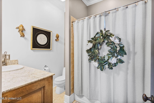 bathroom featuring toilet, vanity, and ornamental molding