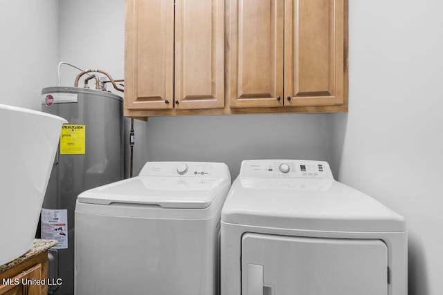 laundry area with washer and clothes dryer, cabinets, and water heater