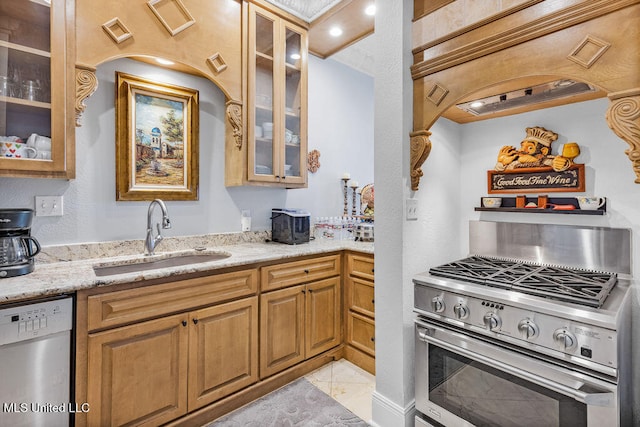 kitchen featuring sink, light stone counters, and stainless steel appliances