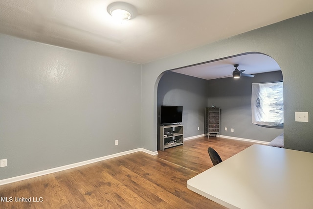 unfurnished living room featuring hardwood / wood-style floors and ceiling fan